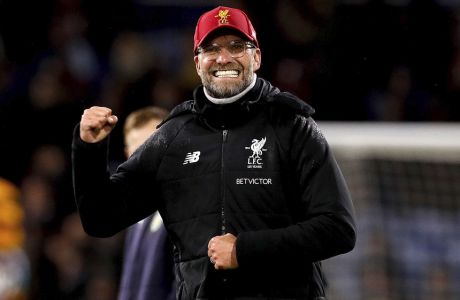 Liverpool manager Jurgen Klopp celebrates after the final whistle of the English Premier League soccer match between Burnley and Liverpool, at Turf Moor, in Burnley, England, Monday Jan. 1, 2018. (Martin Rickett/PA via AP)