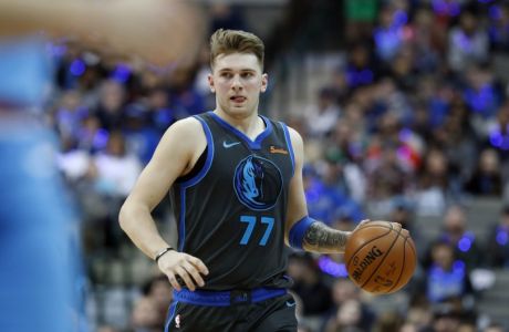 Dallas Mavericks forward Luka Doncic (77) of Serbia dribbles during the second half of an NBA basketball game in Dallas, Sunday, Dec. 16, 2018. (AP Photo/LM Otero)