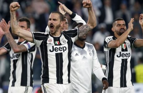 FILE - In this Tuesday, May 9, 2017 file photo, Juventus' Leonardo Bonucci, front, celebrates after the Champions League semi final second leg soccer match between Juventus and Monaco in Turin, Italy.  Juventus defeated Monaco by 2-1.  Juventus keeps on breaking records. And it set another one on Sunday when it clinched an unprecedented sixth successive Serie A title, with one game to spare, following a victory over Crotone. It is the first time since Serie A was founded in 1929 that a club has won six straight titles. (AP Photo/Antonio Calanni, File)