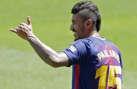 FC Barcelona's new signing Paulinho gestures during his official presentation at the Camp Nou stadium in Barcelona, Spain, Thursday, Aug. 17, 2017. Barcelona has reached a deal with Chinese club Guangzhou Evergrande to buy Brazil midfielder Paulinho for 40 million euros ($47 million). (AP Photo/Manu Fernandez)