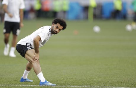Egypt's Mohamed Salah stretches before the start of the group A match between Saudi Arabia and Egypt at the 2018 soccer World Cup at the Volgograd Arena in Volgograd, Russia, Monday, June 25, 2018. (AP Photo/Andrew Medichini)