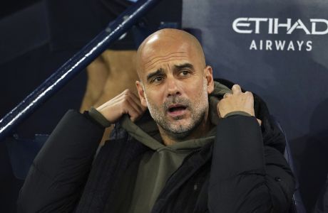 Manchester City's head coach Pep Guardiola sits on the bench prior to the start of the English League Cup third round soccer match between Manchester City and Chelsea at Etihad Stadium in Manchester, England, Wednesday, Nov. 9, 2022. (AP photo/Dave Thompson)