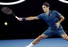 Switzerland's Roger Federer reaches for a forehand return to Uzbekistan's Denis Istomin during their first round match at the Australian Open tennis championships in Melbourne, Australia, Monday, Jan. 14, 2019. (AP Photo/Aaron Favila)
