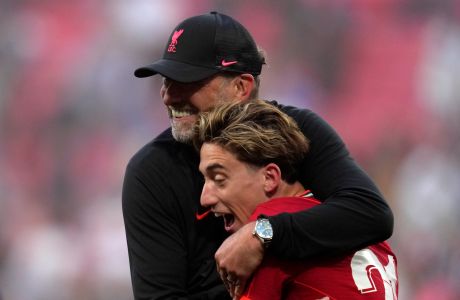 Liverpool's manager Jurgen Klopp celebrates with Liverpool's Kostas Tsimikas at the end of the English FA Cup final soccer match between Chelsea and Liverpool, at Wembley stadium, in London, Saturday, May 14, 2022. (AP Photo/Kirsty Wigglesworth)
