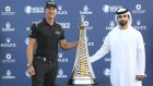 Henrik Stenson of Sweden poses next to Sheikh Mansour bin Mohammed al-Maktoum with the trophy after he won the Race to Dubai at the Jumeirah Golf Estates in Dubai, United Arab Emirates, Sunday, Nov. 20, 2016. (AP Photo/Kamran Jebreili)