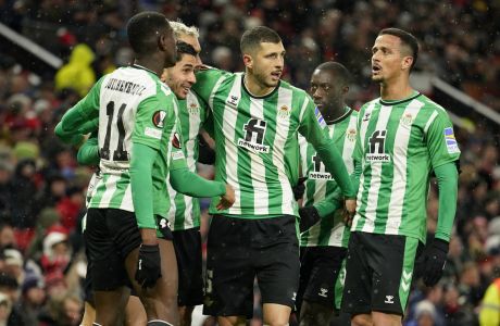 Betis' Ayoze Perez, second left, celebrates after scoring his side's opening goal during the Europa League round of 16 first leg soccer match between Manchester United and Real Betis at the Old Trafford stadium in Manchester, Thursday, March 9, 2023. (AP Photo/Dave Thompson)
