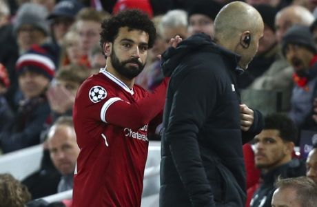 Liverpool's Mohamed Salah leaves the pitch after getting injured during the Champions League quarter final first leg soccer match between Liverpool and Manchester City at Anfield stadium in Liverpool, England, Wednesday, April 4, 2018. (AP Photo/Dave Thompson)
