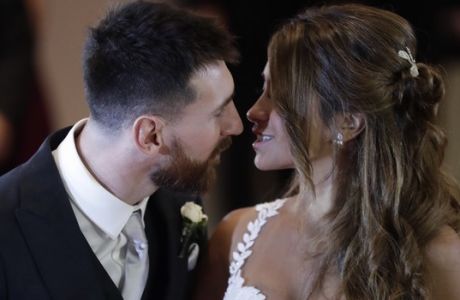 Newlyweds Lionel Messi and Antonella Roccuzzo kiss while posing for photographers on the red carpet after tying the knot in Rosario, Argentina, Friday, June 30, 2017. About 250 guests, including teammates and former teammates of the Barcelona star, attended the highly anticipated ceremony. (AP Photo/Victor R. Caivano)