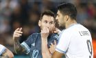 Argentina's Lionel Messi, left, speaks to Uruguay's Luis Suarez during the international friendly soccer match between Argentina and Uruguay in Tel Aviv, Israel, Monday, Nov. 18, 2019. The match ended 2-2. (AP Photo/Ariel Schalit)