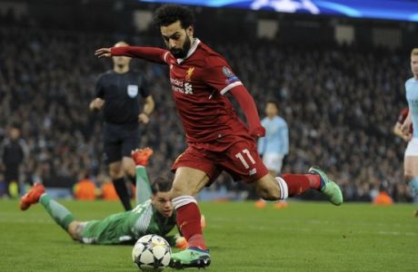 Liverpool's Mohamed Salah scores his side's first goal during the Champions League quarterfinal second leg soccer match between Manchester City and Liverpool at Etihad stadium in Manchester, England, Tuesday, April 10, 2018. (AP Photo/Rui Vieira)