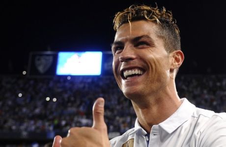 Real Madrid's Cristiano Ronaldo celebrates after winning a Spanish La Liga soccer match between Malaga and Real Madrid in Malaga, Spain, Sunday, May 21, 2017. Real Madrid wins the Spanish league for the first time in five years, avoiding its biggest title drought since the 1980s. (AP Photo/Daniel Tejedor)