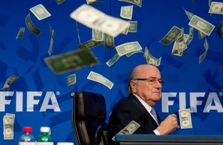 ZURICH, SWITZERLAND - JULY 20: Comedian Simon Brodkin (not pictured) throws cash at FIFA President Joseph S. Blatter during a press conference at the Extraordinary FIFA Executive Committee Meeting at the FIFA headquarters on July 20, 2015 in Zurich, Switzerland. (Photo by Philipp Schmidli/Getty Images)