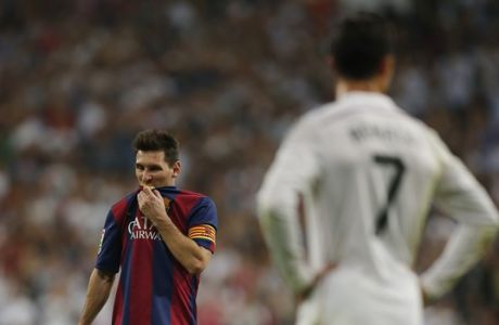 Barcelona's Lionel Messi, left, gestures next to Real Madrid's Cristiano Ronaldo, right,  during a Spanish La Liga soccer match between Real Madrid and FC Barcelona at the Santiago Bernabeu stadium in Madrid, Spain, Saturday, Oct. 25, 2014. (AP Photo/Andres Kudacki)