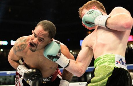 Saul "Canelo" Alvarez, right, lands an uppercut to the jaw of James Kirkland during their 154-pound fight on Saturday, May 9, 2015, in Houston. Alvarez won the bout. (AP Photo/Bob Levey)