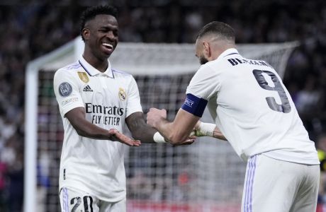 Real Madrid's Karim Benzema, right, celebrates with Real Madrid's Vinicius Junior after scoring his sides first goal during the Champions League, round of 16, second leg soccer match between Real Madrid and Liverpool at the Santiago Bernabeu stadium in Madrid, Spain, Wednesday, March 15, 2023. (AP Photo/Bernat Armangue)