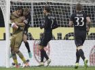 AC Milan goalkeeper Gianluigi Donnarumma is congratulated by teammates after he made last minute save to allow his team to win 1 - 0 during a Serie A soccer match between AC Milan and Juventus, at the San Siro stadium in Milan, Italy, Saturday, Oct. 22, 2016. (AP Photo/Luca Bruno)