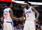 Los Angeles Clippers forward/center Montrezl Harrell, right, smiles as he celebrates with guard Lou Williams after the Clippers defeated the Chicago Bulls 106-101 in an NBA basketball game Friday, Jan. 25, 2019, in Chicago. (AP Photo/Nam Y. Huh)
