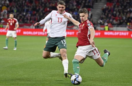 Hungary's Milos Kerkez, right, is challenged by Bulgaria's Yoan Stoyanov during the Euro 2024 group G qualifying soccer match between Hungary and Bulgaria at the Puskas Arena stadium in Budapest, Hungary, Monday, March 27, 2023. (AP Photo/Denes Erdos)
