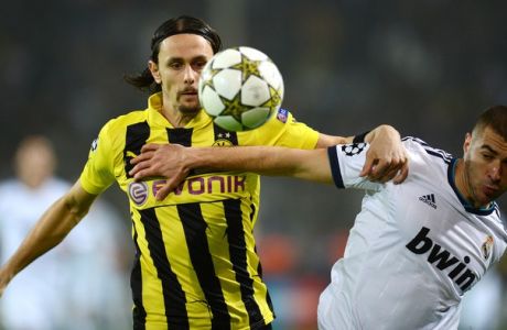 Dortmund's Serbian defender Neven Subotic and Real Madrid's French forward Karim Benzema (R) vie for the ball during the UEFA Champions League Group D football match BVB Borussia Dortmund vs Real Madrid in Dortmund, western Germany on October 24, 2012. AFP PHOTO / PATRIK STOLLARZ        (Photo credit should read PATRIK STOLLARZ/AFP/Getty Images)