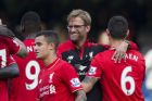 Liverpool's head coach Juergen Klopp, second right, celebrates with his players including goal scorers Philippe Coutinho, third right, and Christian Benteke, 9, on the pitch after the English Premier League soccer match between Chelsea and Liverpool at Stamford Bridge stadium in London, Saturday, Oct. 31, 2015. Liverpool won 3-1. (AP Photo/Matt Dunham)