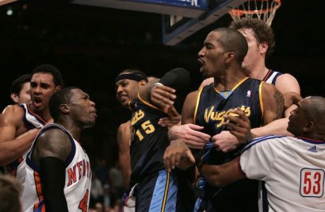 In this Saturday, Dec. 16, 2006 picture, New York Knicks' Nate Robinson, second from left, and Denver Nuggets' J.R. Smith, right exchange words while teammate Carmelo Anthony looks on during a fight that broke out during the second half of basketball action at Madison Square Garden in New York. New York Knicks' Jared Jeffries, left, is restrained. NBA scoring leader Carmelo Anthony was suspended for 15 games Monday, Dec. 18, 2006 and six other players were penalized as commissioner David Stern came down hard on both teams after the Nuggets and Knicks brawled at Madison Square Garden. (AP Photo/Frank Franklin II) MSG112