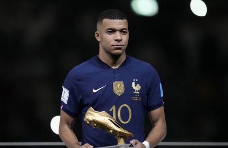 France's Kylian Mbappe holds the Golden Boot award for top goalscorer of the tournament after the World Cup final soccer match between Argentina and France at the Lusail Stadium in Lusail, Qatar, Sunday, Dec. 18, 2022. Argentina won 4-2 in a penalty shootout after the match ended tied 3-3. (AP Photo/Martin Meissner)