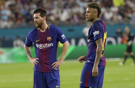 Barcelona's Lionel Messi, left, and Neymar, right, stand on the field during a break in the action during the first half of an International Champions Cup soccer match against Real Madrid, Saturday, July 29, 2017, in Miami Gardens, Fla. (AP Photo/Lynne Sladky)