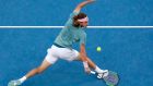 Greece's Stefanos Tsitsipas makes a backhand return to Switzerland's Roger Federer during their fourth round match at the Australian Open tennis championships in Melbourne, Australia, Sunday, Jan. 20, 2019. (AP Photo/Aaron Favila)