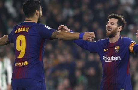 Barcelona's Messi, right, celebrates with teammate Suarez after scoring against Betis during the La Liga soccer match between Barcelona and Betis at the Villamarin stadium, in Seville, Spain on Sunday, Jan. 21, 2018. (AP Photo/Miguel Morenatti)