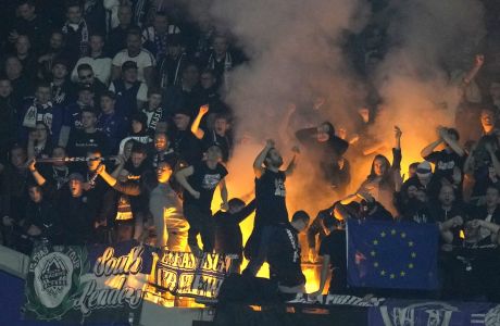 Anderlecht soccer fans set off flares in the stands during the Europa Conference League Group B soccer match between West Ham United and Anderlecht at the London stadium in London, Thursday, Oct.13, 2022. (AP Photo/Kirsty Wigglesworth)