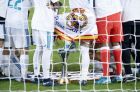 Real Madrid's Sergio Ramos puts his boot on the trophy as the players pose inside the goal after winning the Club World Cup final soccer match between Real Madrid and Gremio at Zayed Sports City stadium in Abu Dhabi, United Arab Emirates, Saturday, Dec. 16, 2017. (AP Photo/Hassan Ammar)