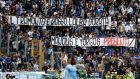 Lazio fans display a banner reading in Italian "Sunset is red, dawn is golden, Manolis and Yorgos, present" during a Serie A soccer match between Lazio and Genoa, at Rome's Olympic stadium, Sunday, Nov. 3, 2013. The banner refers to Manolis Kapelonis and Giorgos Foudoulakis, two members of the Greek far-right Golden Dawn party that were killed in a shooting outside the party's offices last Friday in Athens. (AP Photo/Andrew Medichini)
