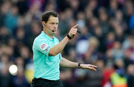 Referee Darren England overturns a goal for Crystal Palace after a VAR check during the second half of an English Premier League soccer match between Crystal Palace and Newcastle at Selhurst Park in London, Saturday, Oct. 23, 2021. (AP Photo/Steve Luciano)