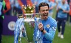FILE - Manchester City's Jack Grealish celebrates with the trophy after winning the 2022 English Premier League title at the Etihad Stadium in Manchester, England, Sunday, May 22, 2022. The Premier League fears a new banking-style soccer regulator could damage the competitiveness of the world's most popular league. The league's chief executive Richard Masters has also raised concerns that proposed measures would impact its value and deter investment into a competition that earns billions of dollars through the sale of broadcast rights across the globe. (AP Photo/Dave Thompson, File)