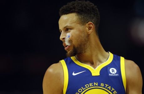 Golden State Warriors guard Stephen Curry chews on his mouthguard during the first half of an NBA basketball game against the Los Angeles Clippers, Monday, Oct. 30, 2017, in Los Angeles. (AP Photo/Ryan Kang)