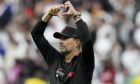 Liverpool's manager Jurgen Klopp gestures on the pitch before the Champions League final soccer match between Liverpool and Real Madrid at the Stade de France in Saint Denis near Paris, Saturday, May 28, 2022. (AP Photo/Manu Fernandez)
