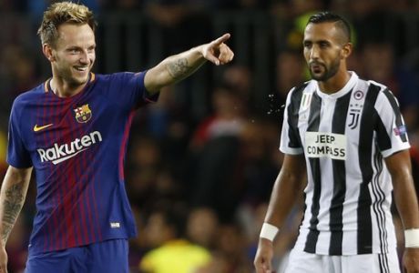 Barcelona's Ivan Rakitic, left, celebrates after scoring his side's second goal as Juventus' Medhi Benatia, right, watches during a Champions League group D soccer match between FC Barcelona and Juventus at the Camp Nou stadium in Barcelona, Spain, Tuesday, Sept. 12, 2017. (AP Photo/Francisco Seco)