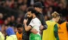 Liverpool's manager Jurgen Klopp hugs substituted Liverpool's Mohamed Salah during the FA Cup quarterfinal soccer match between Manchester United and Liverpool at the Old Trafford stadium in Manchester, England, Sunday, March 17, 2024. (AP Photo/Dave Thompson)