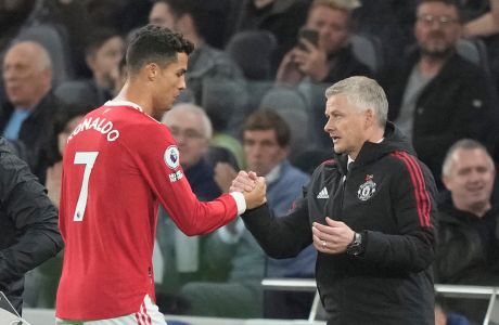 Manchester United's Cristiano Ronaldo, left, greets Manchester United's manager Ole Gunnar Solskjaer as he is replaced by Manchester United's Marcus Rashford during the English Premier League soccer match between Tottenham Hotspur and Manchester United at the Tottenham Hotspur Stadium in London, Saturday, Oct. 30, 2021. (AP Photo/Frank Augstein)
