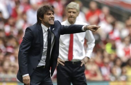 Chelsea team manager Antonio Conte, left, gestures as Arsenal team manager Arsene Wenger watches during the English FA Cup final soccer match between Arsenal and Chelsea at the Wembley stadium in London, Saturday, May 27, 2017. (AP Photo/Matt Dunham)