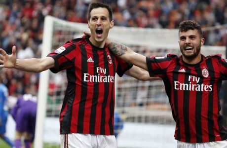 AC Milan's Nikola Kalinic, left, celebrates with his teammate Patrick Cutrone after scoring his side's third goal during the Serie A soccer match between AC Milan and Fiorentina at the San Siro stadium in Milan, Italy, Sunday, May 20, 2018. (AP Photo/Antonio Calanni)
