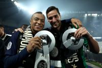 Paris Saint-Germain's Kylian Mbappe, left, celebrates with Paris Saint-Germain's Spanish goalkeeper Sergio Rico the French Ligue 1 championship's trophy during a ceremony following the French L1 football match between Paris Saint-Germain (PSG) and Toulouse, Sunday, May 12, 2024 at the Parc des Princes stadium in Paris. (Franck Fife, Pool via AP)