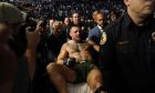Conor McGregor is carried off on a stretcher after losing to Dustin Poirier in a UFC 264 lightweight mixed martial arts bout Saturday, July 10, 2021, in Las Vegas. (AP Photo/John Locher)