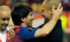FC Barcelona's Lionel Messi from Argentina, left,  celebrates his victory with coach Josep Guardiola during the final Copa del Rey  soccer match against Athletic Bilbao at the Vicente Calderon stadium in Madrid, Spain, Friday, May 25, 2012. (AP Photo/Andres Kudacki)