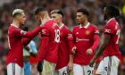 Manchester United's Casemiro, second left, is consoled by teammates after being shown a red card by referee Anthony Taylor during the English Premier League soccer match between Manchester United and Southampton at Old Trafford stadium in Manchester, England, Sunday, March 12, 2023. (AP Photo/Jon Super)