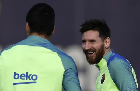 FC Barcelona's Lionel Messi, right, smiles next to his teammate Luis Suarez during a training session at the Sports Center FC Barcelona Joan Gamper in Sant Joan Despi, Spain, Saturday, March 11, 2017. FC Barcelona will play against Deportivo Coruna in a Spanish La Liga on Sunday. (AP Photo/Manu Fernandez)