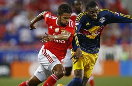 SL Benfica midfielder Mehdi Carcela-Gonzalez, left, battles New York Red Bulls defender Anthony Wallace for the ball during the first half of a soccer match in the International Champions Cup in Harrison N.J., Sunday, July 26, 2015. The Red Bulls defeated Benfica 2-1. (AP Photo/Rich Schultz)
