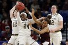 Notre Dame's Arike Ogunbowale (24) grabs a rebound against Texas A&M's Aja Ellison (0) during the second half of a regional semifinal game in the NCAA women's college basketball tournament, Saturday, March 30, 2019, in Chicago. (AP Photo/Nam Y. Huh)
