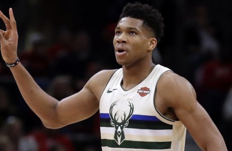 Milwaukee Bucks forward Giannis Antetokounmpo gestures to the bench after Eric Bledsoe scored a basket during the second half of an NBA basketball game against the Chicago Bulls, Sunday, Jan. 28, 2018, in Chicago. (AP Photo/Nam Y. Huh)