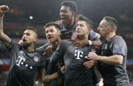 Bayern's Robert Lewandowski, second right, celebrates with teammates after scoring a penalty during the Champions League round of 16 second leg soccer match between Arsenal and Bayern Munich at the Emirates Stadium in London, Tuesday, March 7, 2017. (AP Photo/Frank Augstein)